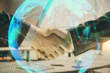 Multi exposure of financial chart and map on office background with two businessmen handshake. Concept of success in business