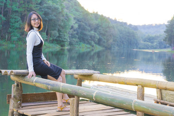 Asian woman sitting on raft.