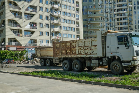Big white truck at a construction site on a sunny day, Batumi