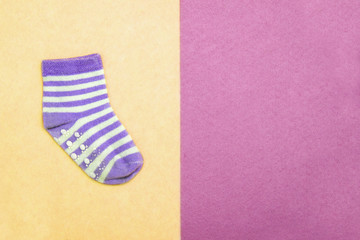 Sock for child. Top view. Violet striped socks on pink, yellow backgrounds. Abstract seamless texture in the style of pop art