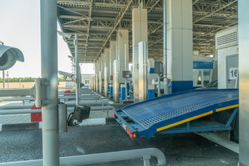 Tow truck passes the entry point to the toll road on a sunny day