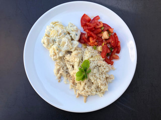 Chicken risotto on plate. Traditional italian cuisine meal, with mixed salad and herbs.