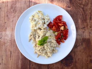 Chicken risotto on plate. Traditional italian cuisine meal, with mixed salad and herbs.