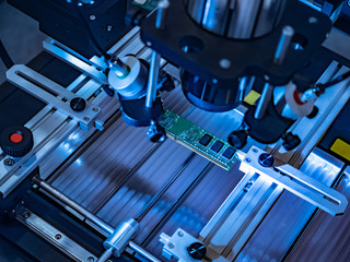 Robotic equipment for the production of printed circuit boards. Chips are attached to the base...