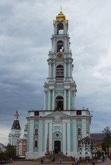 Fototapeta na wymiar Sergiyev Posad, Russia. - May, 2019: Belfry in Trinity Sergius Lavra, Sergiyev Posad, Russia. Beautiful bell tower of an old Russian church.