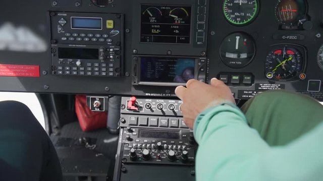 Close-up: Helicopter Pilot Touching Buttons on Dashboard  - Vancouver, Canada