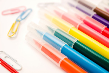 back to school. Colorful stationary school supplies markers for drawing on white background, space or text flat lay