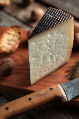 Cured cheese with rustic background