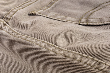 clothing items stonewashed cotton fabric texture with seams, clasps, buttons and rivets, macro