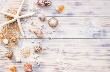Fototapeta na wymiar Starfish with sea shells on white wooden background.