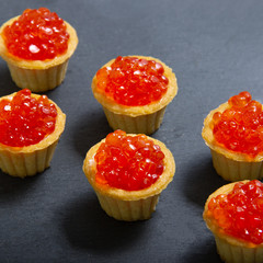 Tartlets with red caviar. Selective focus, space for text . serve red caviar