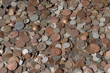 Old vintage fake coins background for sale to tourists in the Indian market on the street in Rishikesh, India. Close up