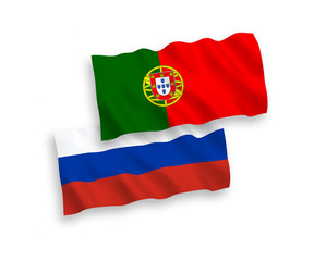 National vector fabric wave flags of Portugal and Russia isolated on white background. 1 to 2 proportion.