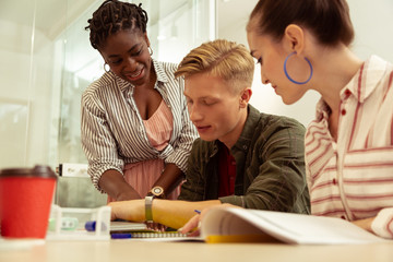 Positive delighted international tutor consulting her students