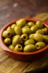 Green Spanish olives in clay bowl