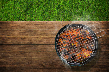 Burning barbecue on grass background