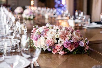 Wine glasses in the foreground. Wedding Banquet or gala dinner. The chairs and table for guests,...