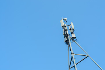 Cellular antenna on blue sky background,copyspace.