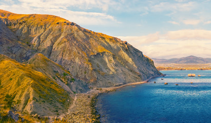 Fototapeta na wymiar summer sea scene, mountain cliff above a sea bay