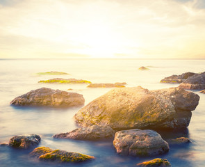 early morning sea coast scene, sunrise over the stony sea coast