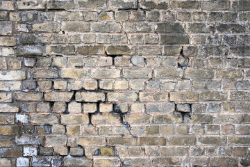 old cracked  gray brick wall
