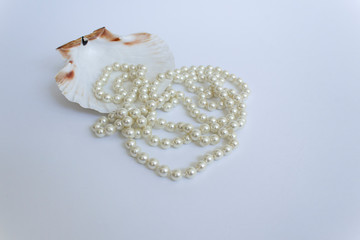 white wedding pearl accessory necklace on sea shell background