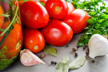Preparation marinated conservation tomatoes with herbs, garlic, salt, and spice.