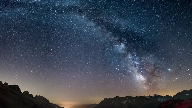 The Milky Way arch starry sky on the Alps, Massif des Ecrins, Briancon Serre Chevalier ski resort, France. Panoramic view high mountain range and glaciers, astro photography, stargazing