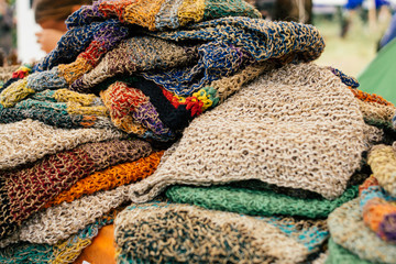 Hemp clothes. Colored hemp caps in the market. Eco concept