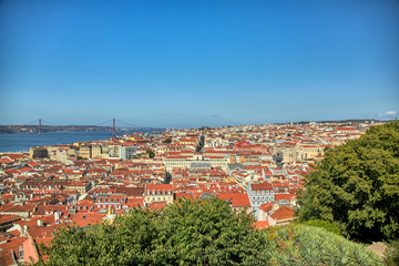Fototapeta na wymiar Views of Lisbon where you can see the roofs of their houses and Tagus River.