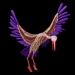 Embroidery stork soars with spread wings on a black background.