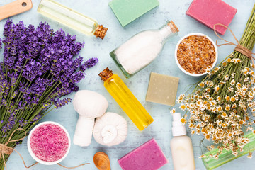 Grooming products and fresh lavender bouquet on white wooden table background.