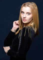 Fototapeta premium beautiful blonde woman in black velvet dress with epulet.