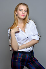 beautiful blonde woman in white shirt and checked trousers