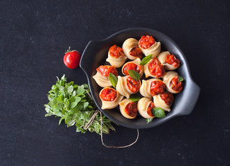 Stuffed large shells pasta with meat and tomatoes in sauce. Conchiglioni Italian cuisine. Copy space.