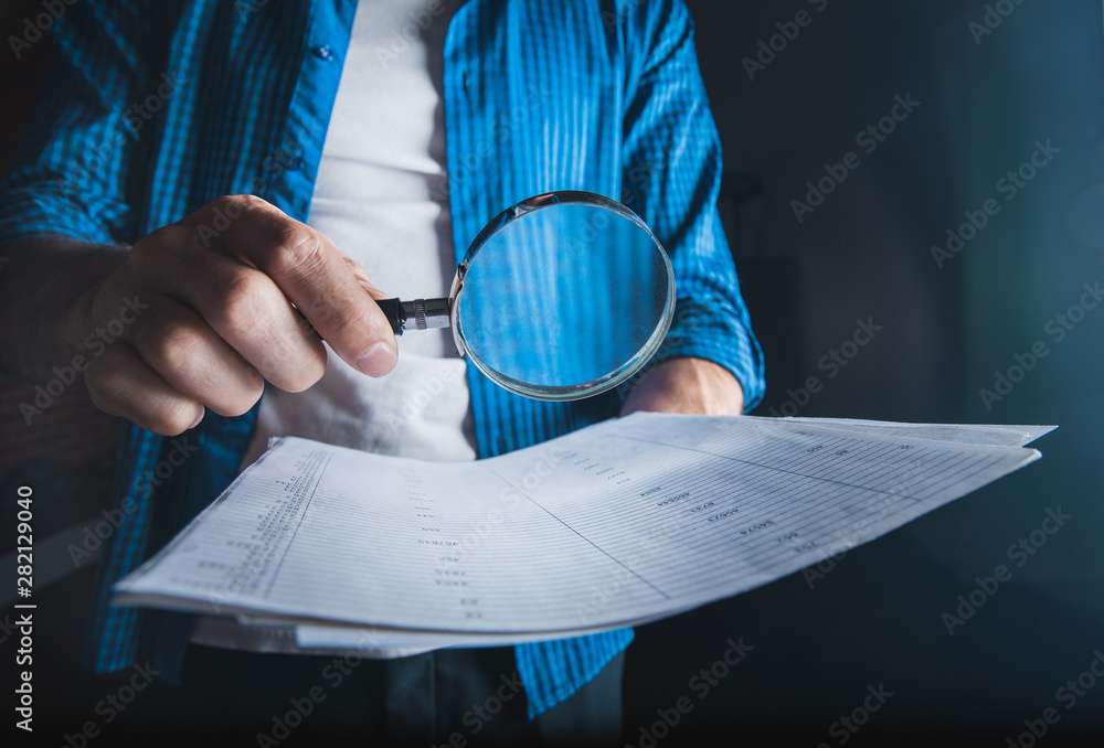 Poster man hand document with magnifier on dark background