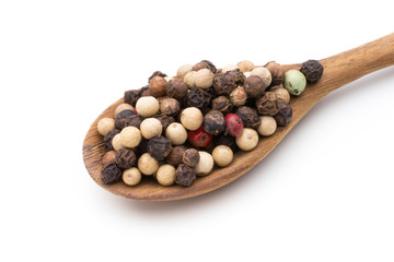 Pepper mix seed on spoon on white background.