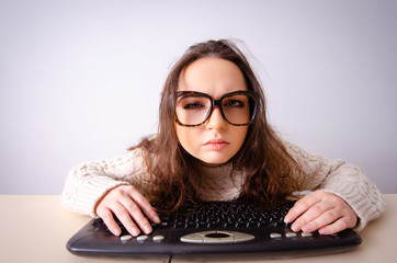 Funny nerd girl working on computer