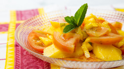 Tomato salad with mango. Summer meal.