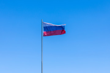 The government flag of Russia or Russian Federation on the sky background