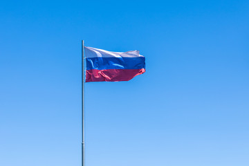 The government flag of Russia or Russian Federation on the sky background