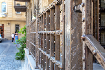 Metal railing with rivets on the porch of a stone house