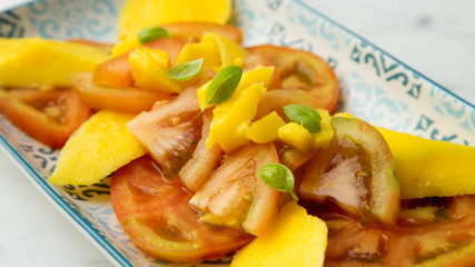 Tomato salad with mango. Summer meal.
