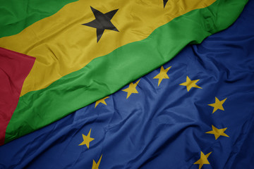 waving colorful flag of european union and flag of sao tome and principe.