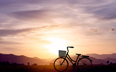 Fototapeta premium Silhouette women bike at sunset on mountain hills and sky cloud. Vector illustration design
