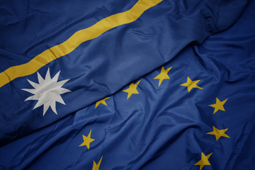 waving colorful flag of european union and flag of Nauru .