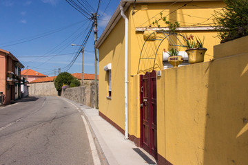 Fototapeta na wymiar Portugal, unknown village - 06/10/2018: road in small portuguese village with old buildings. Travel in Europe. Rural landmark. Traditional spanish and portuguese house exterior. Summer tourism concept