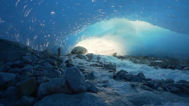 Slow Motion/Forward: Splashing, Quick Moving Stream Over Rocky Ground In Glacier Cave - Mendenhall Glacier, Alaska