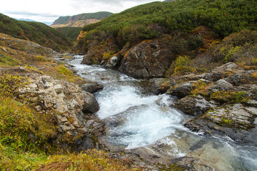 Naklejka na ściany i meble Beautiful waterfall in mountains, scenic autumn landscape in Kamchatka