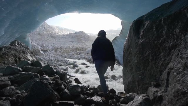 Slow Motion/Forward: Walking On Rocky Ground Inside Glacier Cave By Flowing Stream - Mendenhall Glacier, Alaska